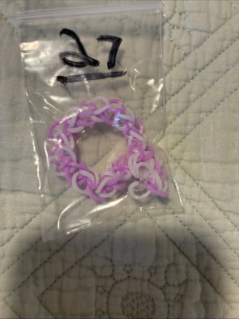 Purple and white rubber band bracelet